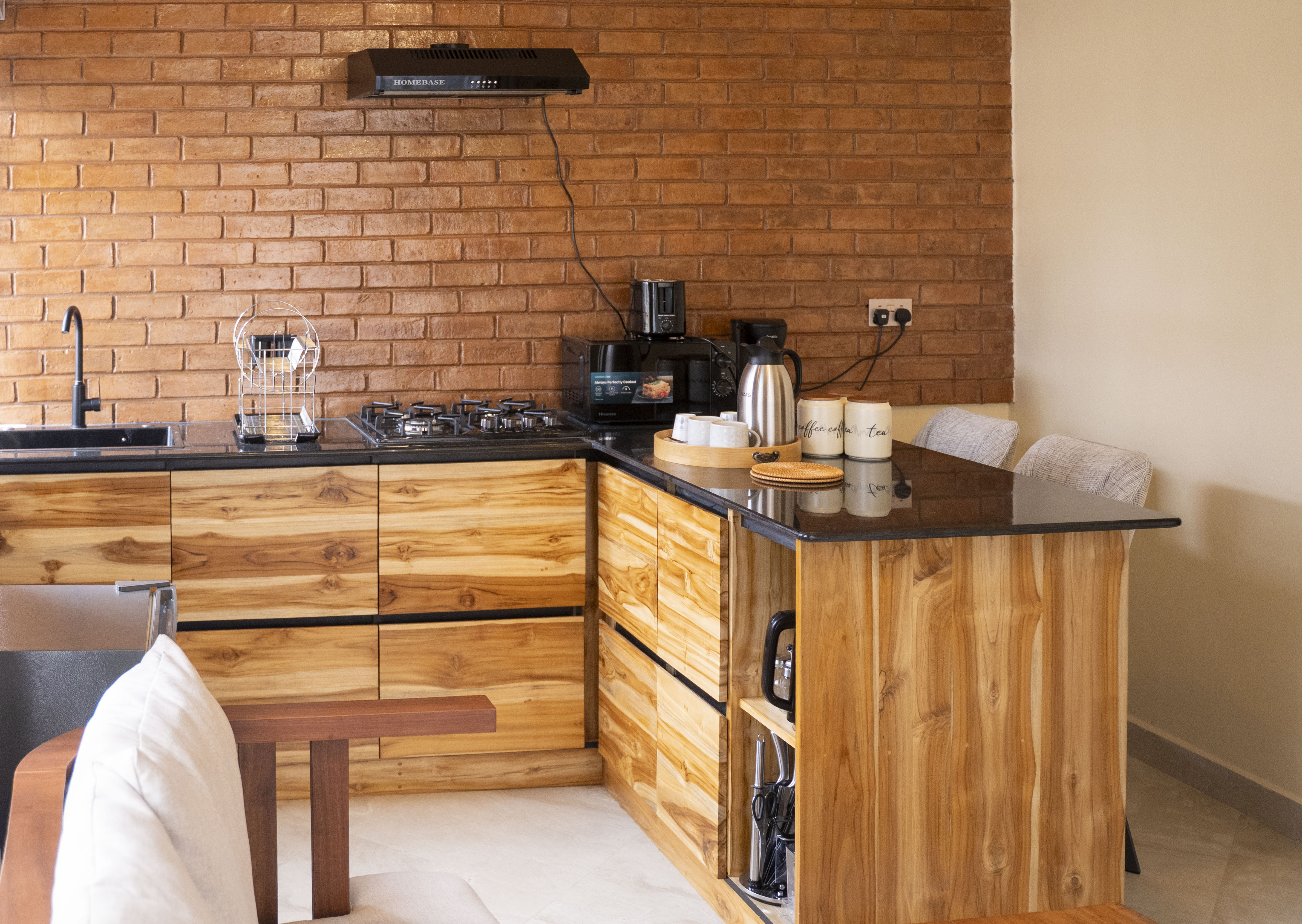 The fully-equipped kitchen — black granite countertops, gas hob and handcrafted teak cabinetry